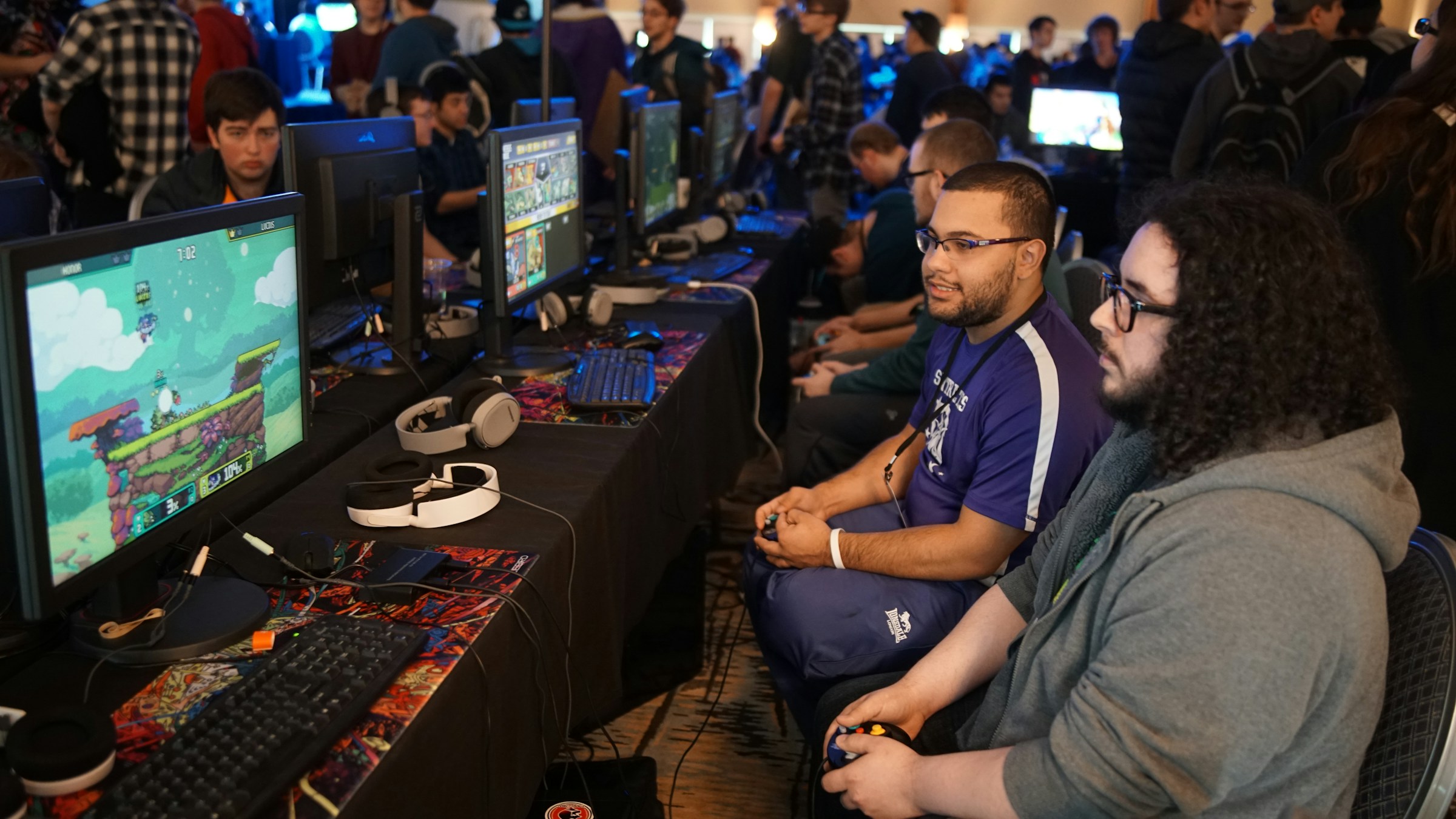 Players competing together at gaming stations A group of players competing together at gaming computers