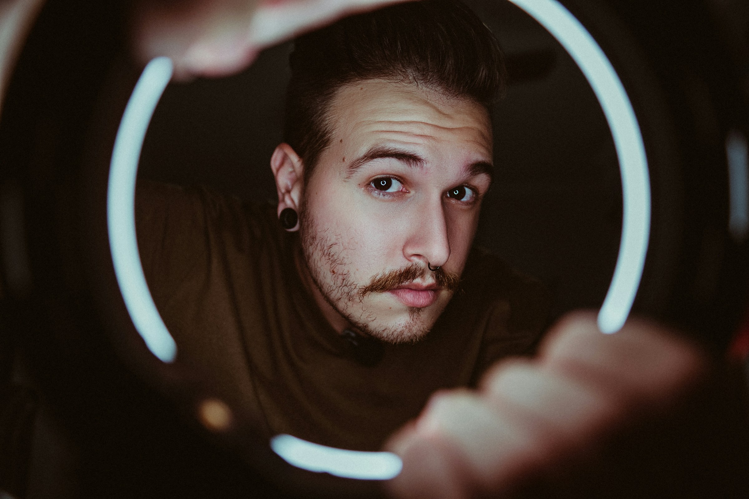 Online content creator framed by a ring light Online content creator framed by a ring light